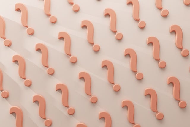 Large group of question marks on a wall